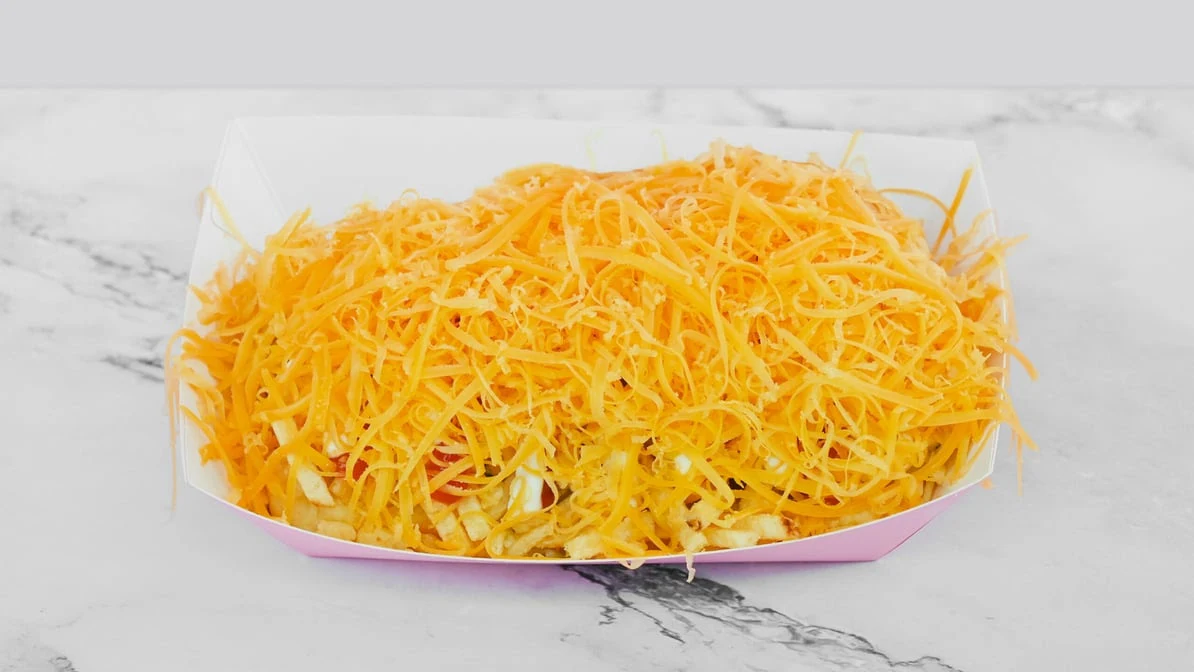 Cheddar Hot Dog - Delicious hot dog smothered in melted cheddar cheese.