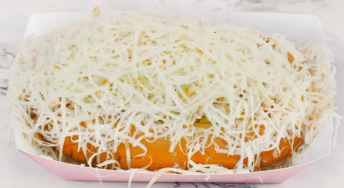 El Sifrino Hot Dog - Bread, sausage, corn, onion, cabbage, 3 sauces, chips, Munster cheese and bacon.